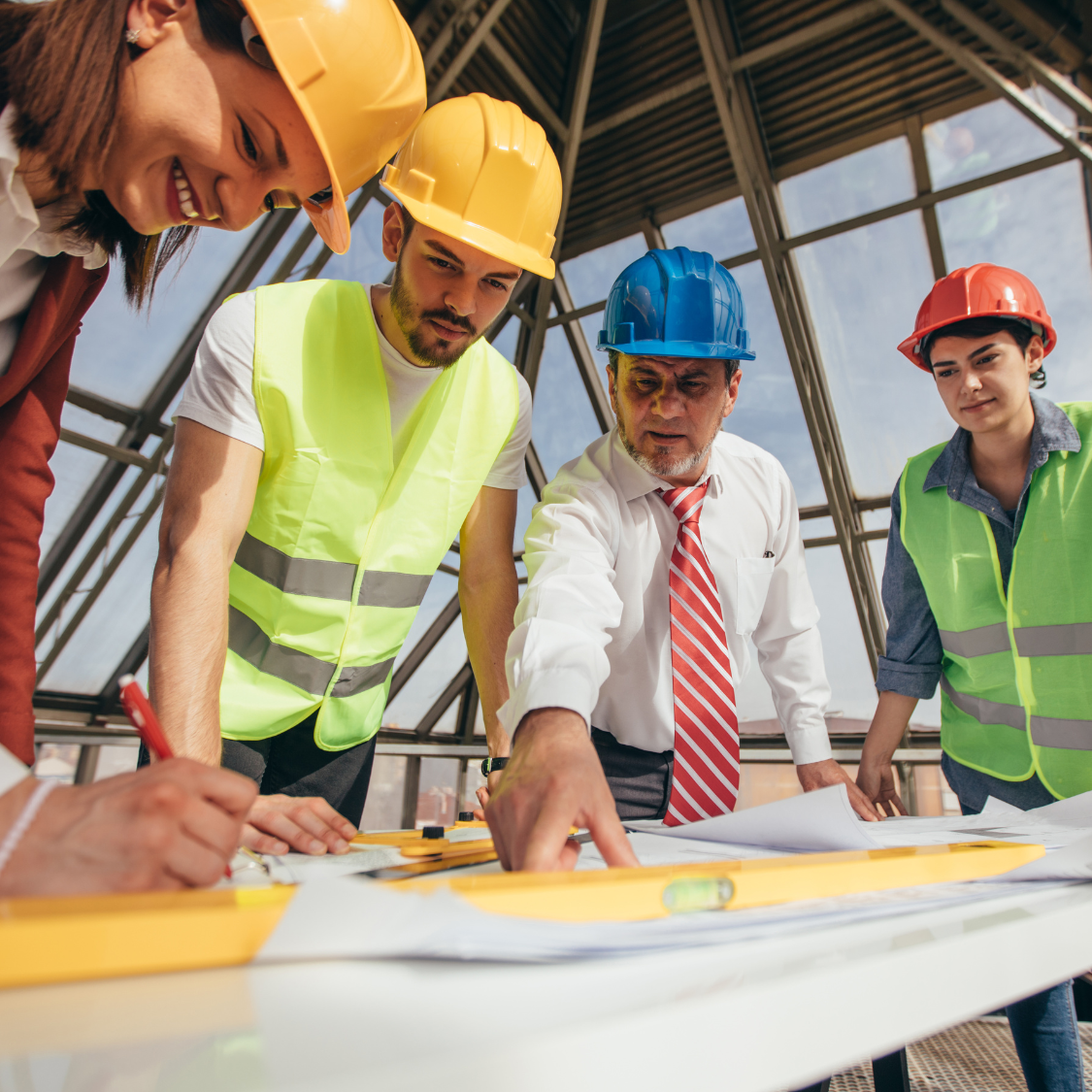 construction team standing over blueprints