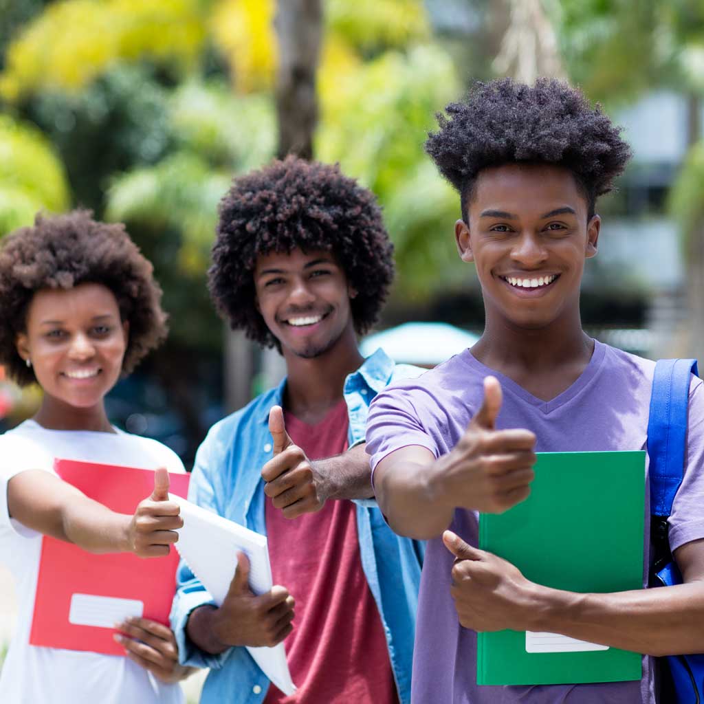 Group of three African American college students giving a thumbs up