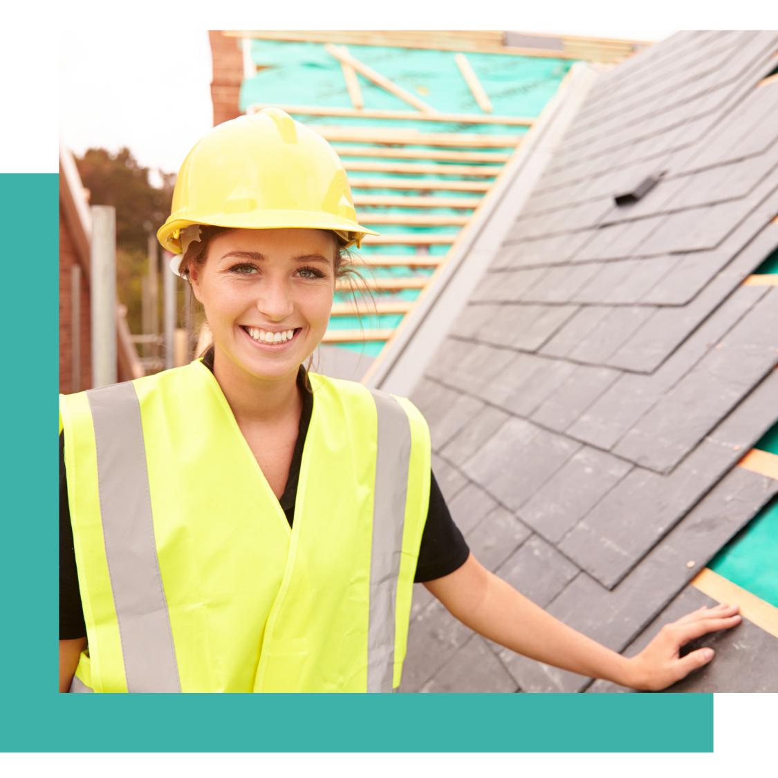 female construction working standing on roof smiling for photo